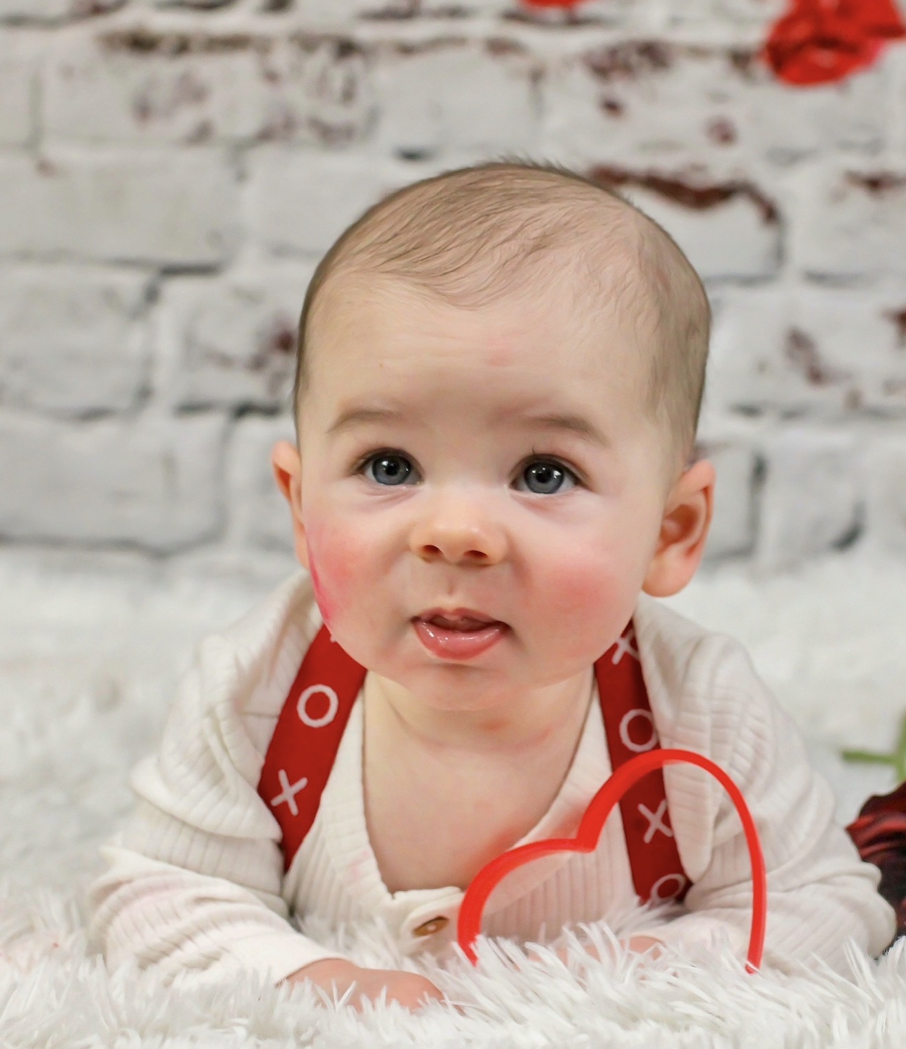 Baby wearing a red holiday outfit