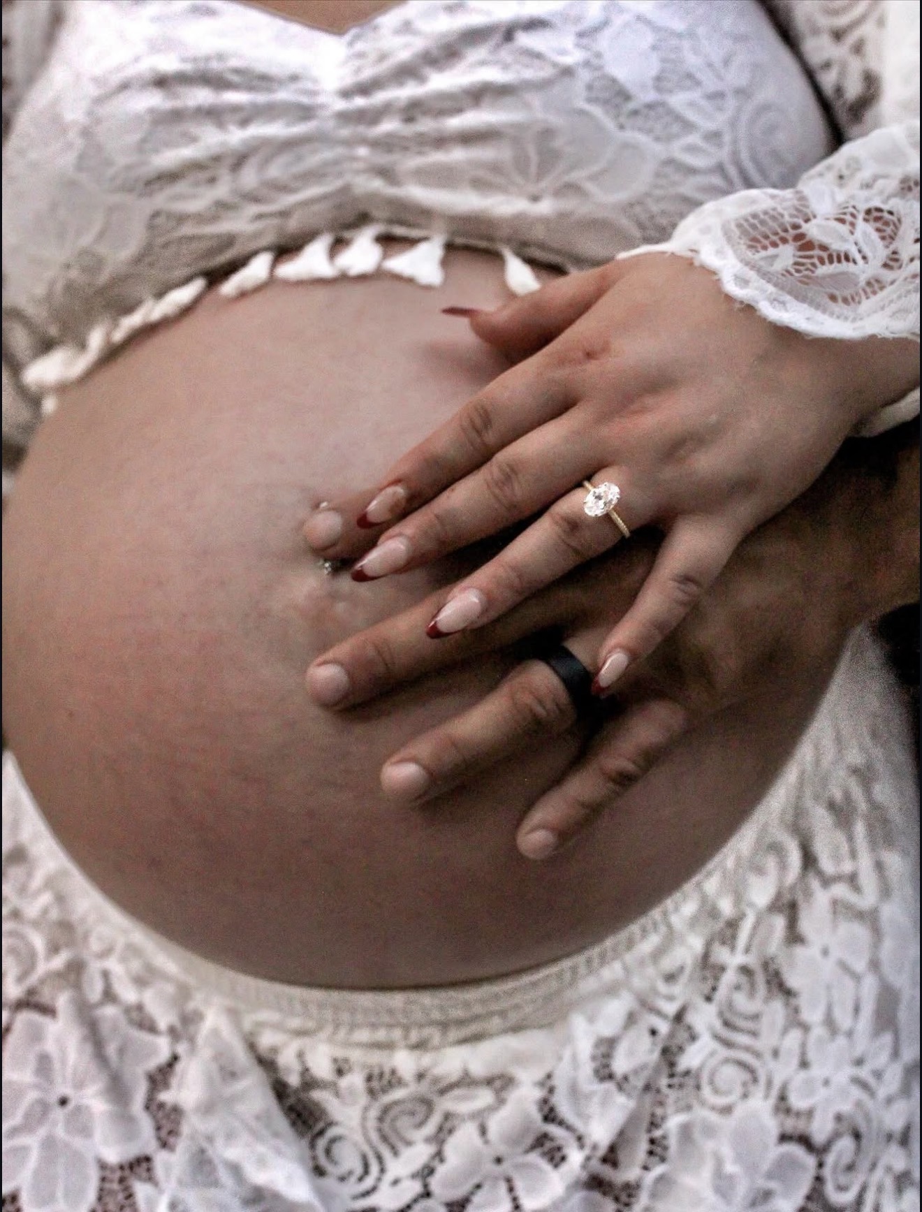 Maternity portrait showing a wedding ring